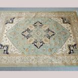 A Heriz style rug, with a central medallion, on a green ground,