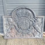 A large cast iron fire back, relief decorated with a unicorn and lion,