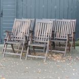 A set of eight teak reclining folding garden armchairs