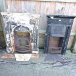 A cast iron fire insert, together with another smaller,