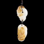 A GROUP OF CHINESE WHITE AND RUSSET JADE PENDANTS