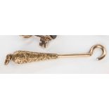 A yellow gold button hook, tear drop handle with engraved decoration, 2in. (5cm.) long.