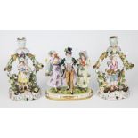 A Meissen style figure, depicting a top-hat and tailed dandy gentleman with two female companions,