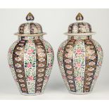 A pair of Japanese Imari jars and covers, ovoid form with alternating blue then white ground