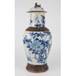 A Japanese blue and white crackle glazed vase, of waisted ovoid form with cover, the cover painted