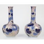 A pair of early 20th century Japanese porcelain bottle vases, blue leaf and grape decoration over