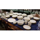 A Limoges porcelain dinner service, gilt wheat sheaf and burgundy border.