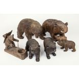 Six carved wooden Black Forest bears, various sizes, largest being 9 x 5in. wide (12.7 x 22.8cm.),