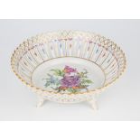 A Dresden porcelain floral sprigged reticulated basket, 20th century, raised on four feet,