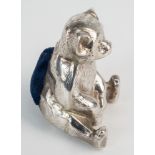 A novelty Edwardian silver teddy bear pin cushion, Boots Pure Drug Company, Birmingham 1909, with