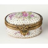 A Continental porcelain patch box, 19th century, oval form, floral bouquet design to face of