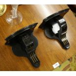 A pair of late Victorian ebonised clock or wall brackets