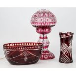 Ruby flashed cut-glass lamp, bowl and vase, the electric lamp with compressed globular shade over