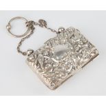 An Edwardian silver ring purse, Birmingham 1903, repousse scrolling foliate decorated hinged