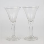 A pair of Georgian wine goblets, circa 1760, large drawn trumpet form bowls on stems with tear drops