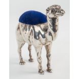 An Edwardian silver novelty camel pin cushion, Adie & Lovekin Ltd., Birmingham 1905, with blue