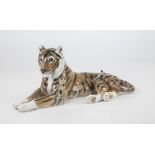 A Royal Copenhagen porcelain tiger, no.714, 1980-1984, 12in. (30.5cm.) long.