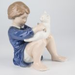 A Royal Copenhagen figure of a girl brushing a cat, c.1975-1979, no.4631, designed by John