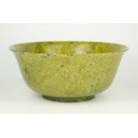 A Chinese spinach jade bowl, Qianlong style but possibly later, flared rim descending into deep