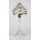 A cut glass lamp, dome form shade with graduated diamond cut design above a horizontal band of small