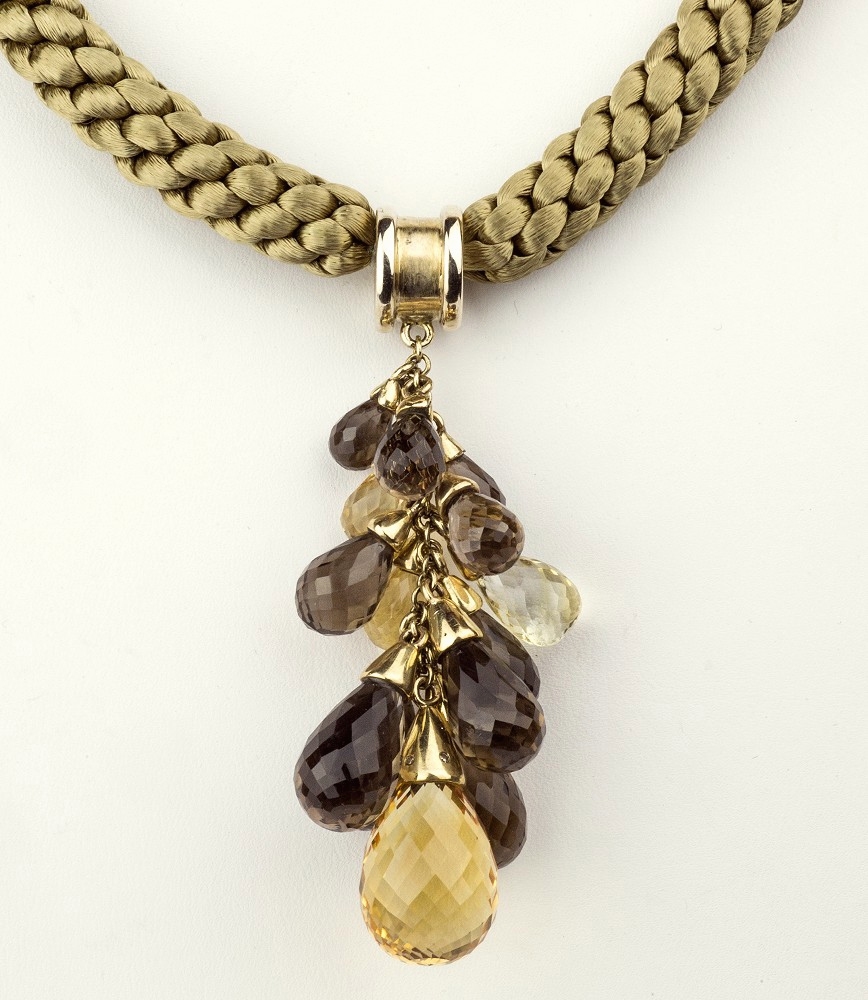 A two-colour gold, citrine and smoky quartz briolite cut pendant, the pendant suspending four