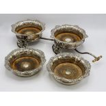 A silver plated decanter carriage, early 20th century, two plated coasters with scroll and shell