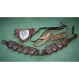 A British WW1 period leather nine pocket bandolier, together with a mid-20th century leather and