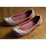 A pair of Indian Jutti shoes, early 20th century, red leather uppers over hand stitched leather