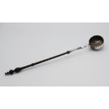 A 19th century silver toddy ladle, the bowl with repousse floral and foliate design, inset to base