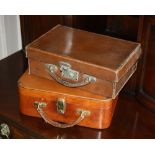 A leather travel vanity case, mid-20th century, interior with plastic pots and bottles, twist brass