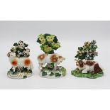 Two small Staffordshire porcelaneous bocage figures, 19th century, comprising a cow and a standing