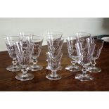 A matched set of ten small wine glasses, early 20th century, the plain funnel bowls with basal