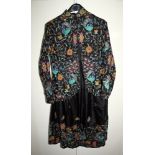 A vintage 1970s Monsoon two piece jacket and skirt, black with Indian style embroidery of peacocks