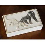 A Japanese relief carved ivory box, Meiji period, rectangular form, the lid with crouching leopard