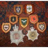 Seven wooden wall plaques, including regimental plaques for the Brigade of Gurkhas and RCT, plus