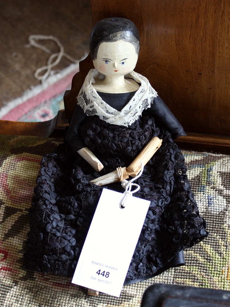 A Victorian Grodnertal wooden peg doll, circa 1840, wooden head with painted features, in black