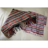 Two Victorian striped silk shawls, one shaped and padded with blue silk lining and long fringe, the