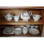 A Rockingham style porcelain part tea and coffee service, mid-19th century, gilt and grey scrolling