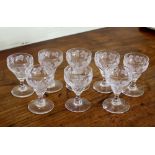 A matched set of eight Victorian cut and engraved small wine glasses, the ogee bowls with wheel