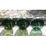 Three green glass fishing floats,