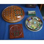 Two treen solitaire boards, one of circular form, the other smaller and square, together with a