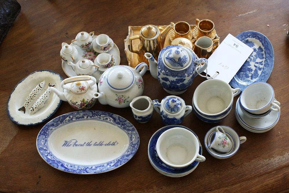 A small collection of child's miniature part tea services,