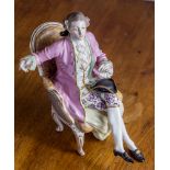 A Continental porcelain figure of a seated dandy, 19th century, possibly La Courtille, seated in