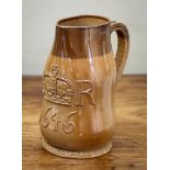 A Doulton Lambeth stoneware commemorative pitcher, in the form of a leatherjack, manufactured for