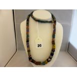 An Egyptian faience necklace, 1920s, comprising multi coloured beads, approximately 35 inches long