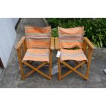 Two vintage beach directors chairs with original striped canvas covers.