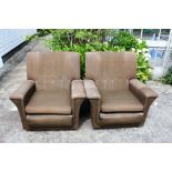 A pair of brown upholstered vintage retro cocktail style armchairs.