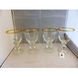 A set of four Sark wine glasseswith amber coloured upper rim.