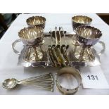 A silver plated breakfast set of four egg cups, tray, napkin ring plus eight silver spoons.