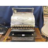 An antique British made Stevensons National cash registermetal plated with embossed scrolling and